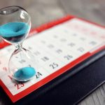 Hour glass on calendar concept for time slipping away for import
